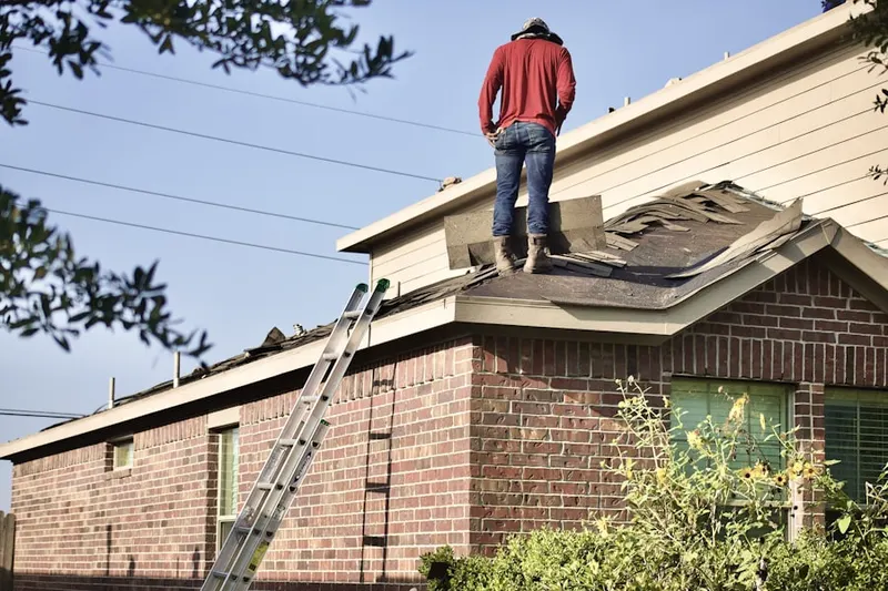 Professional roofer working on a residential roof in Kingfisher